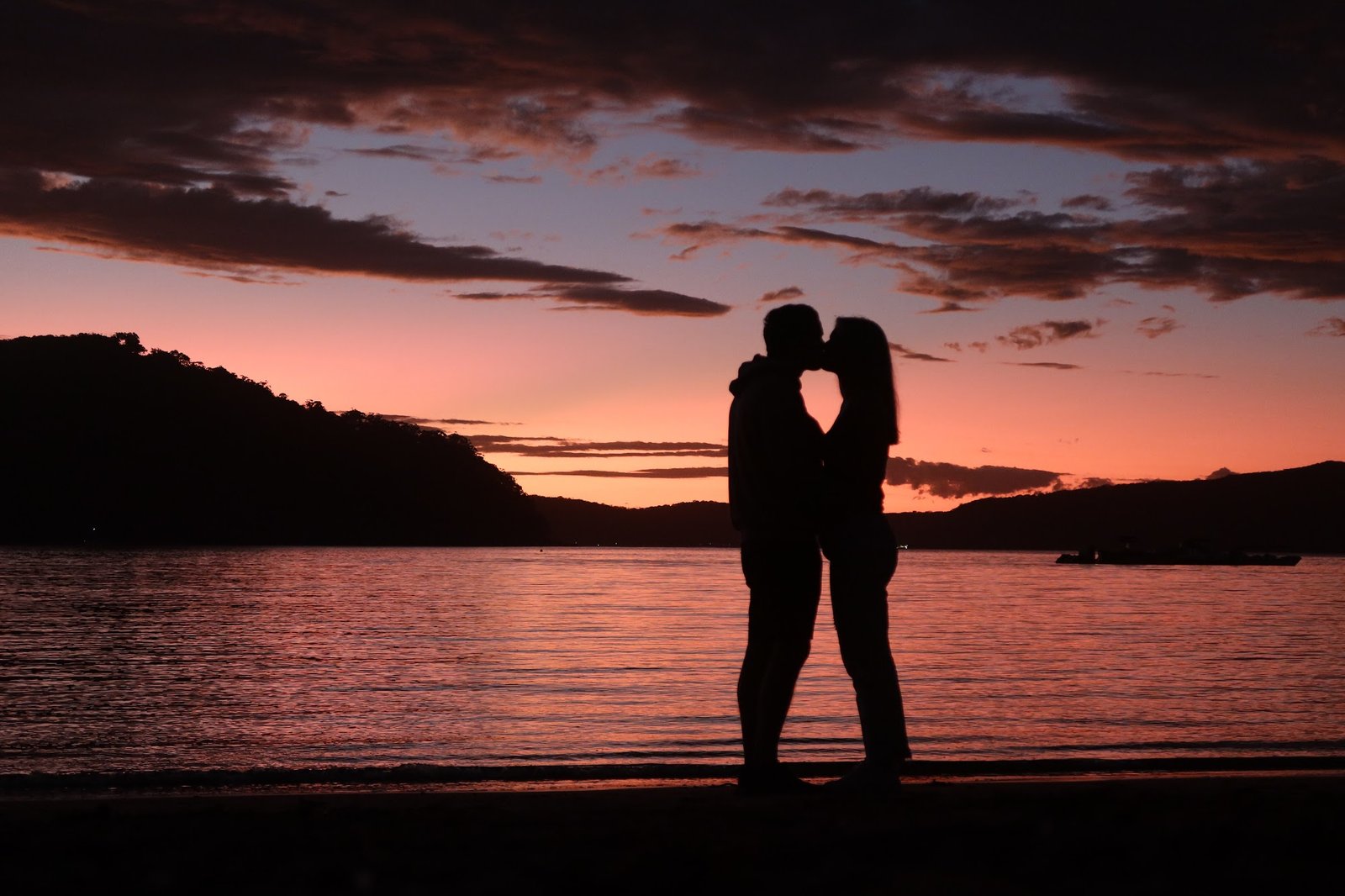 Daniel and Lauren kissing at sunset